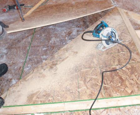 Standing Up the Walls: Sheathing is nailed on and trimmed in place.