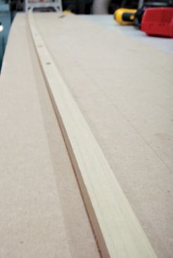 A thin strip of straight-grained poplar described the curve for the router to follow in cutting the template.