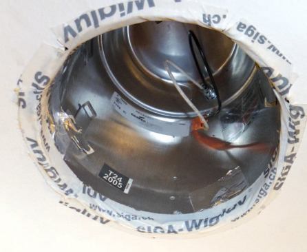 The much larger — and often overlooked — leak between the fixture and the ceiling drywall has been sealed with tape.