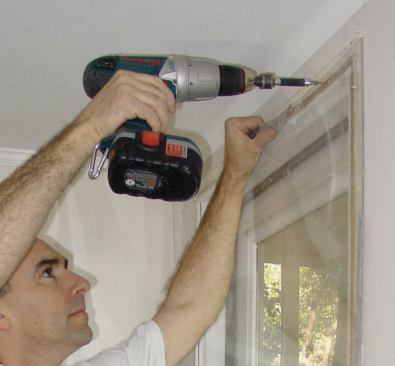 Protective sheets of 1/4-inch plexiglass are fastened to door or window jambs with screws driven through slightly oversized predrilled holes in the plexiglass.
