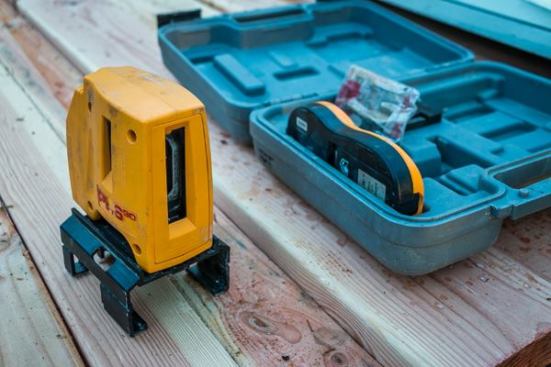 We have been using a Pacific Laser Systems 
PLS90E since 2007 for foundation work and shooting square layout onto the deck. This self-leveling laser is a real time saver. Because it shoots lines 90° from each other that project onto both horizontal and vertical surfaces, we can use it to lay out stepped foundations—either for the dirt work or for laying out pony walls on a walk-out basement or stepped foundation. We also use it to transfer layout from the floor to a vaulted ceiling to avoid snapping lines on the vault, which reduces the amount of time we spend on a ladder.