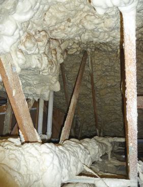 Framed with a combination of standard and raised-heel scissors trusses, the conditioned attic was insulated with low-density open-cell foam sprayed on the underside of the roof sheathing.