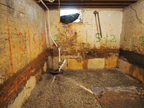 A new sump pit is installed and the subslab stone is placed.