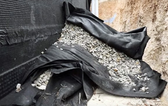 On top of this, another layer of filter fabric is layered. That is covered by yet another layer of fabric.