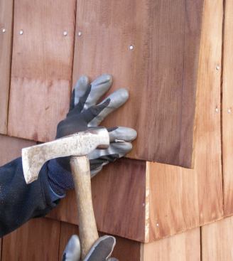 Outside Corners: To start a corner, nail up the first shingle so that it overhangs the corner by at least an inch. Use extra nails at both the tip and the butt to prevent this first shingle from moving or pivoting during trimming.