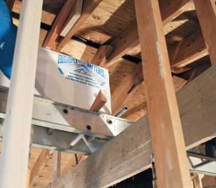 Inside the house, we used 1-inch-diameter pipes to roll the beam into place.