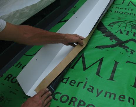 Next, fold the flashing tape back on top of the continuous flashing.