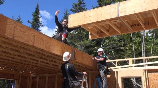 EcoCor panelized the second floor frame as well as the walls for the house. Top, the crew sets a floor panel section into place.