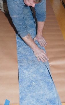 I measured and cut the 14-inch-wide perimeter membrane fabric, leaving enough for about a 4-inch overlap. Then, following the manufacturer's instructions, I prebent a 2-inch leg along one edge.