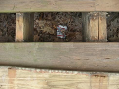 When I removed three deck boards closest to the house to start working on the ledger, I found a series of old beer cans, perhaps an indication of how seriously the original deck builders took their workmanship.