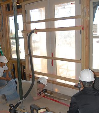 French doors have a reputation as being leak-prone, but most problems stem from improper installation. Here, a spray-rack test shows water leaking between the sill and the subfloor.