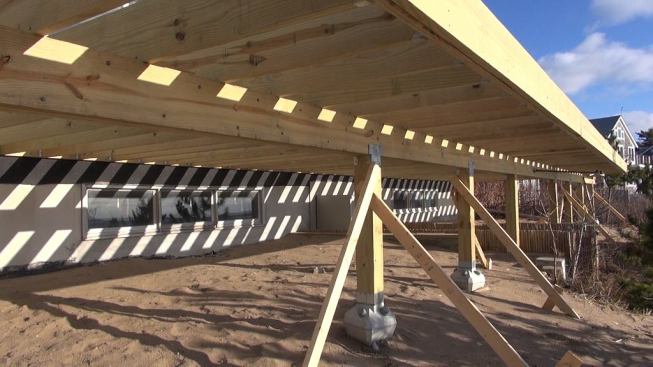 Diamond Pier footings and posts in place under the completed portion of the deck.