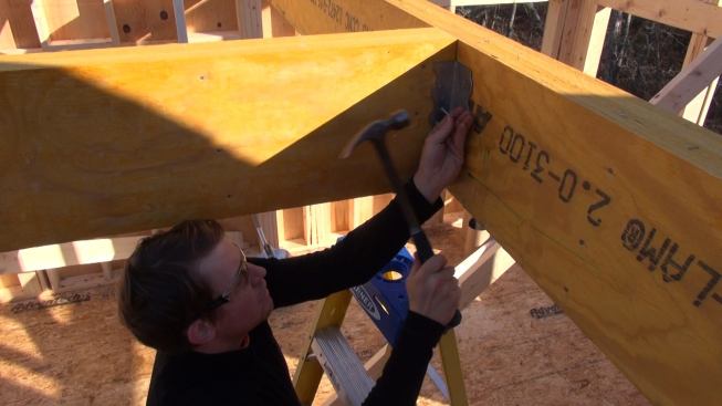 Laffin nails off the Simpson connector to the LVL beam joint.