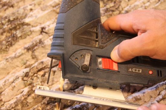 The black lever, a staple on Bosch's jigsaws, is right where you need it so adjusting the oscillating action is easy. The sliding on-off switch means no realtime variable speed, a feature that's not missed on this saw. The LED on-off switch is readily available, and battery gauge comes on automatically when the tool is on.