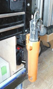 I'm really not crazy about any particular caulk gun; I like the no-drip style and it has to have a poker stick. I store my caulk gun on the cart in the Caulked-and-Ready holder. The holder has a bottom so if the gun leaks it won’t drip onto the floor. There are openings on either side so you can clean the bottom out.