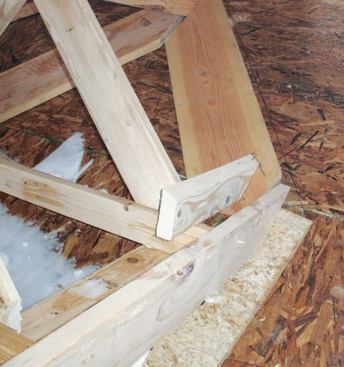 Scribing the Valleys: We now had a pattern in place — the gable sheathing — from which we could accurately project the curve of the roof from front to back. The top of the 2x6 subfascia defined the bottom edge; the flare would smoothly transition into the straight 2x6 rafters at its top. The first step in the process was to cut plates for the valleys out of 2x12 stock and position these between the subfascia and the ridge.