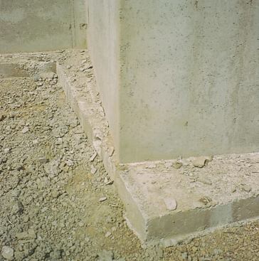 This incorrectly placed footing caused the foundation wall to be off-center. If the soil is very strong, this may not lead to problems. If the footing is on a weaker soil however, the author will recommend that it be fixed.