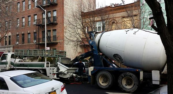 Concrete for the new buttress structure had to be pumped in from the street. Here, the concrete truck and pump truck are parked in front of the house.