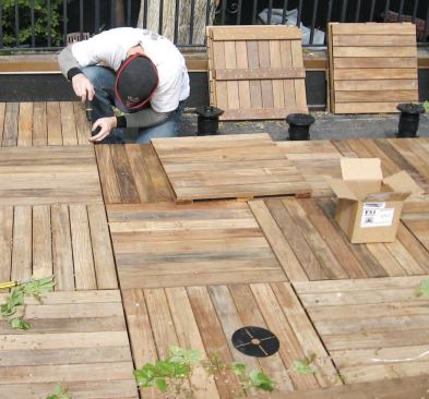 Tiles and pedestals are installed and leveled one at a time.