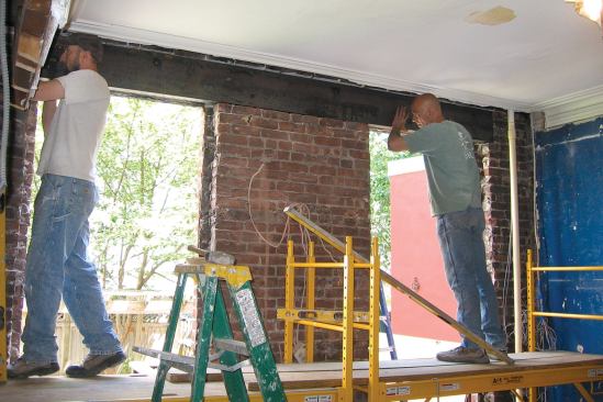 The outer wythe of brick will remain in place during the installation to maintain the wall's structural integrity.