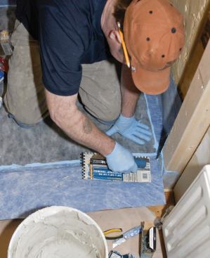 Then I bedded the membrane onto the threshold with my trowel.