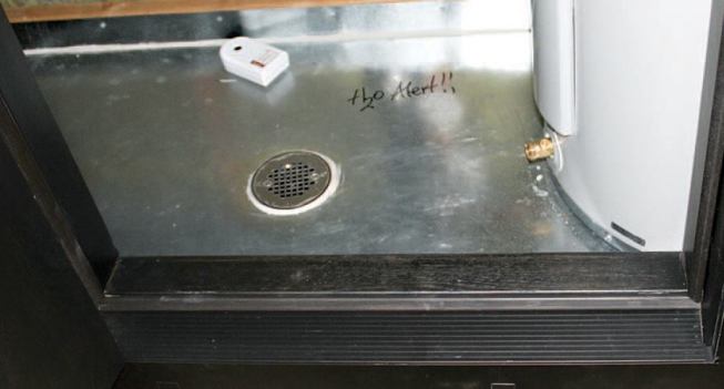 The subfloor was lined with a galvanized pan fitted with a drain.