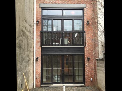 To finish out the exterior, we installed an applied “lintel” over the masonry opening to match the existing window heads. The lintel was made from a two-coat stucco application. We used a Portland-cement-and-sand-mix scratch coat, set in mesh, and a tinted finish coat. Also, we installed a temporary Juliet balcony, which serves as a guardrail until we build the deck off the first-floor kitchen next year.