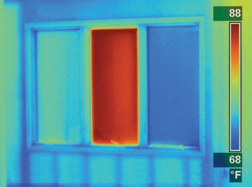 This infrared photo was taken on a cool (30°F) winter day. Notice how hot the high-solar-gain glass (at center) is relative to the other windows.