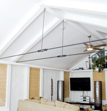 The support trusses do more than just free up space in the center of the room — they create a visual break between the new kitchen and the existing great room.