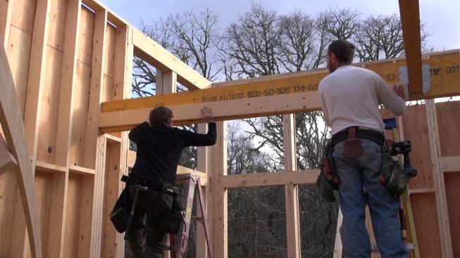 Preparing to fill in the floor framing, Hill and Laffin set a temporary 2x6 ledger board to catch the ends of the 4x8 Doug Fir floor joists for the loft floor frame.