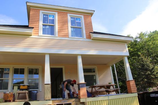 Another look at the front of the home. With upper level trim details complete, the crew is working on wrapping the front porch columns.