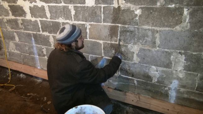 Joe Martignetti repoints the interior of the basement wall in early winter of 2014. This wall face later received a cementitious parge, but remained vapor and air permeable.