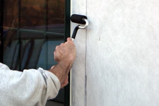 I always use a J-roller to apply strong, even pressure to the flashing tape.