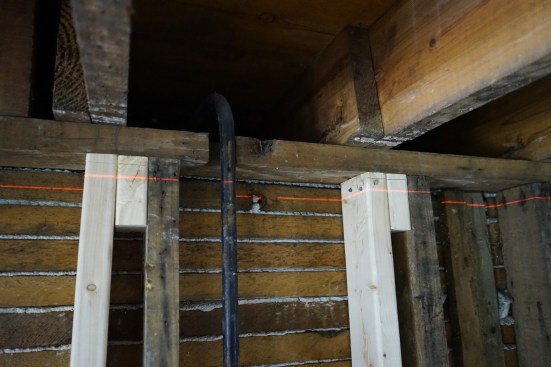 When the new beam in the basement is level, the wall has been raised more than an inch. 