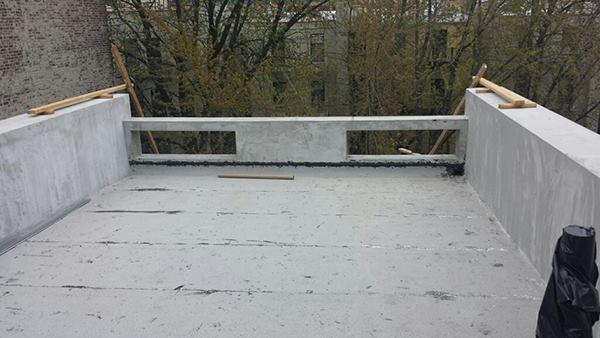 The completed exterior insulation finish system (EIFS) cladding sits ready for additional roofing and flashing details.