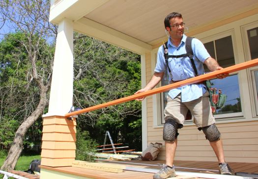 Pollard sets the top rail in place.