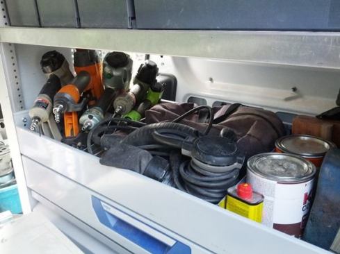 There is open divided storage at a convenient height (in the middle). Above that there are bins that lock onto tracks in the shelving unit.