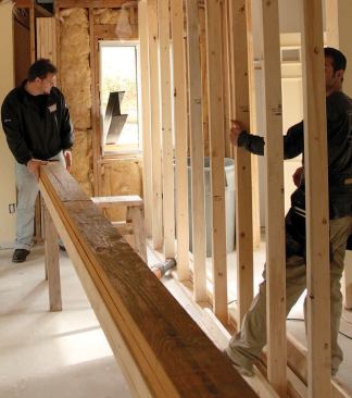 The crew hauled the 460-pound beam inside through a convenient window and set it on sawhorses beneath its eventual location in the ceiling.