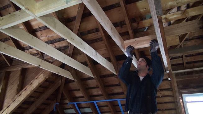 Mark Pollard installs blocking into the new ceiling for the upstairs space.