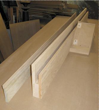 The jig holds the casing on edge with only the profiled, mitered portion exposed.
