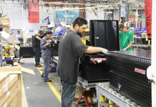 Here workers do the final assembly of Weather Guard boxes. I expected to see industrial impact drivers but they were using the same cordless tools used on the jobsite. The impact drivers shown here are DeWalt 20V MAX models but I also saw some Makitas. Some of the older tools (DeWalt and Makita) were incredibly beat, used so hard sections of the housings were worn through—and yet they still worked. I don’t have photos because the tour guide gave me the look that meant “It’s time to put the camera down dude”.