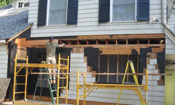 Next, we took out the windows, leaving as much of the framing intact as we could, then removed the rim joist and exposed the ends of the second-floor joists.