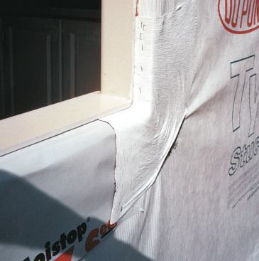 After pulling out the window, the author's crew repapered the wall with Tyvek StuccoWrap, then applied membrane and Tyvek FlexWrap to the rough sill to protect the wood structure even if the window leaks.