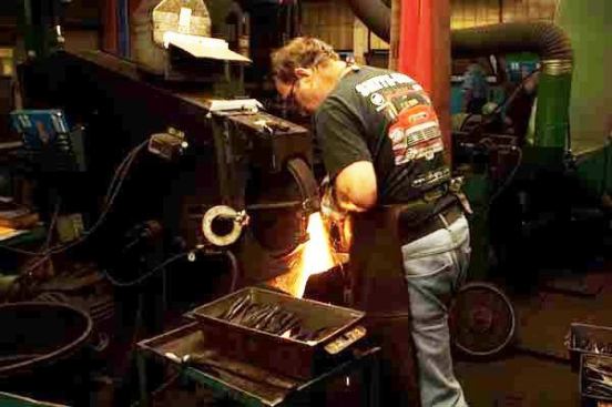 Hand grinding the heads of pliers for a finished appearance.
