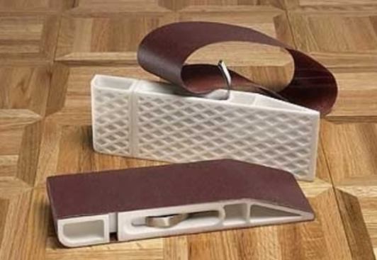 This extremely handy sanding block uses a standard 3x21 belt sanding belt. Unlike a homemade wood block, the paper stays taut. This tool is great for easing edges, prepping the edges of flake board to receive peel-and-stick edge banding, and anything else that requires you to leave a very crisp edge.