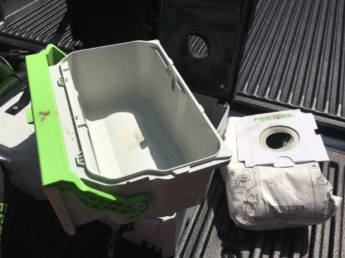 Here, the dust bag has been removed to show the canister. It's large enough to fit a good deal of fine dust from sanding or when making small cuts.