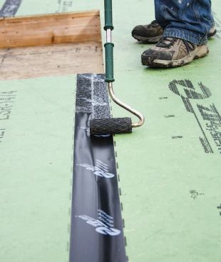 Applying tape with a J-roller.