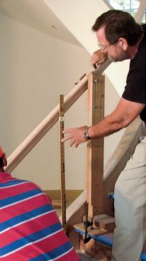 The author adjusts it at various points on the stair until its height is as uniform as possible and falls within the 34- to 38-inch range specified by code.