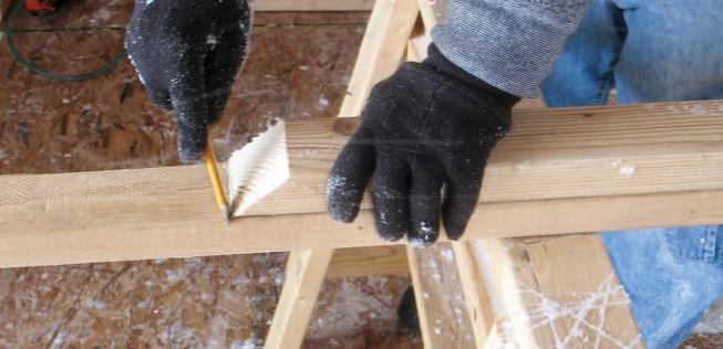 Wall Layout: Frame members are beveled at one end to match the roof pitch, then nailed together.