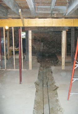 To accommodate the bearing walls for a stairway, the 12-inch-deep by 24-inch-wide footing widens to 5 feet at one end of the basement.
